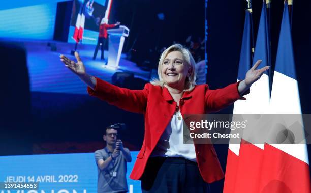 France's far-right party Rassemblement National leader, Marine Le Pen, candidate for the 2022 French presidential election waves her supporters prior...