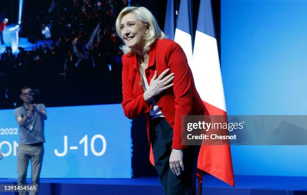 France's far-right party Rassemblement National leader, Marine Le Pen, candidate for the 2022 French presidential election waves her supporters prior...