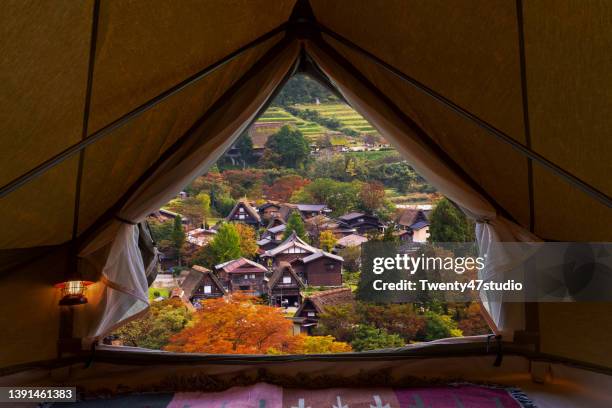 autumn landscape view from inside the tent - shirakawa go stock pictures, royalty-free photos & images