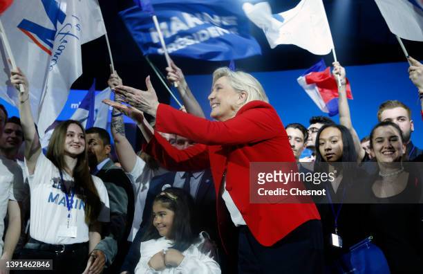 France's far-right party Rassemblement National leader, Marine Le Pen candidate for the 2022 French presidential election waves her supporters at the...