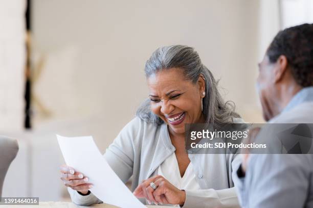 excited senior adult woman - two bank managers talking stock pictures, royalty-free photos & images