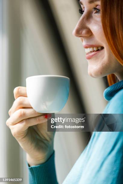 happy young woman contemplating about her day while enjoying coffee - leisure work coffee happy stockfoto's en -beelden