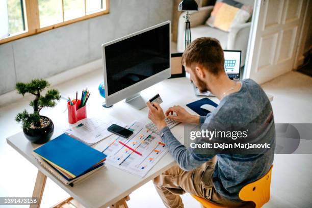 single person shopping at home using credit card - auction table stock pictures, royalty-free photos & images