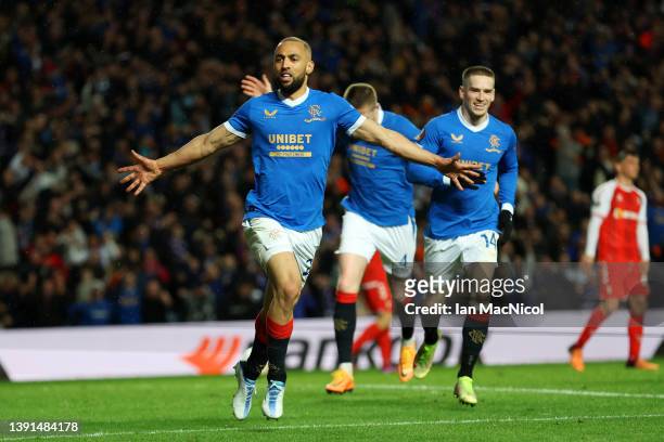 Kemar Roofe of Rangers celebrates with teammates John Lundstram and Ryan Kent of Rangers after scoring their team's third goal during the UEFA Europa...