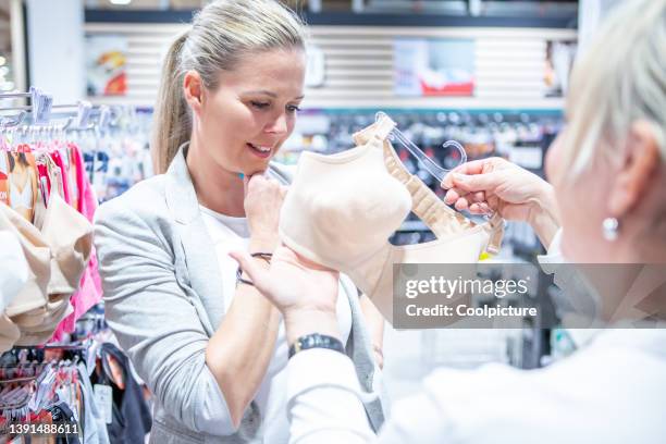 woman with shop assistant  in a  shopping mall - victoria's secret stock pictures, royalty-free photos & images