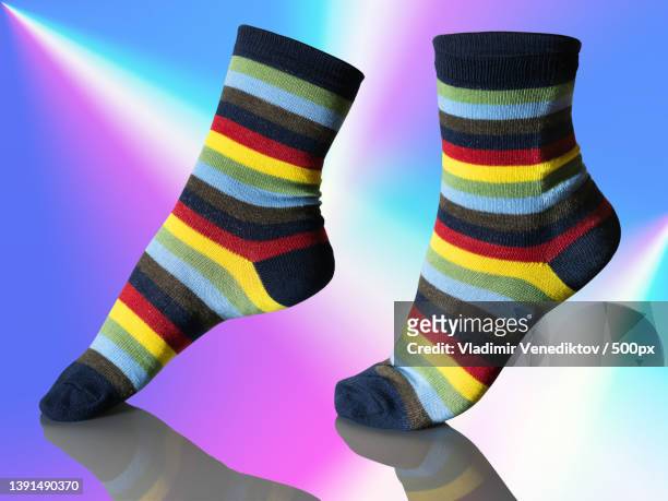 multicolored socks on a rainbow background - striped socks stock pictures, royalty-free photos & images