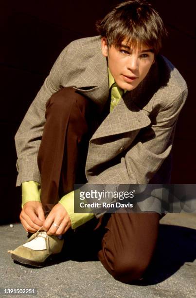 American actor and producer Josh Hartnett, ties his shoe while posing for a portrait circa 1997 in Los Angeles, California.