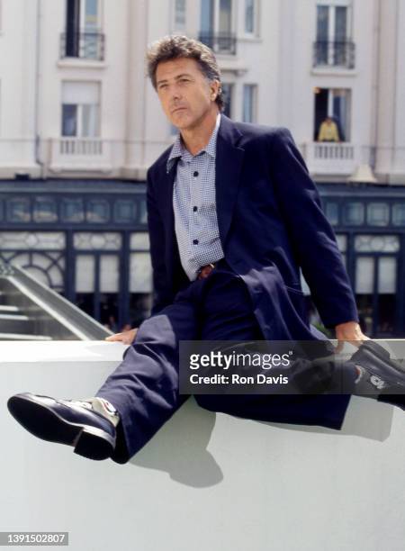 American actor and filmmaker Dustin Hoffman, poses for a portrait as he sits on a ledge circa 1995 in Los Angeles, California.