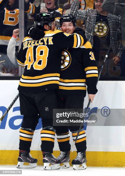 Jesper Froden of the Boston Bruins celebrates with Matt Grzelcyk after scoring his first NHL goal during the first period against the Ottawa Senators...