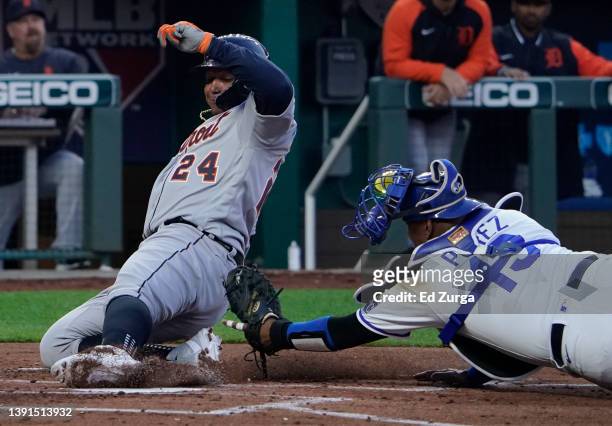 Miguel Cabrera of the Detroit Tigers scores against Salvador Perez of the Kansas City Royals in the second inning at Kauffman Stadium on April 14,...