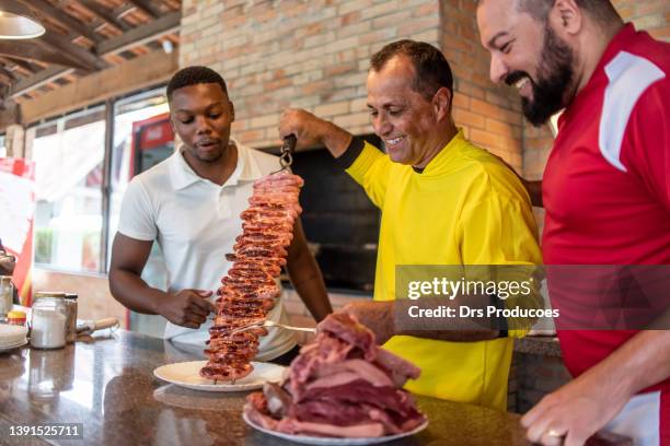 friends preparing barbecue after soccer game - meal kit stock pictures, royalty-free photos & images