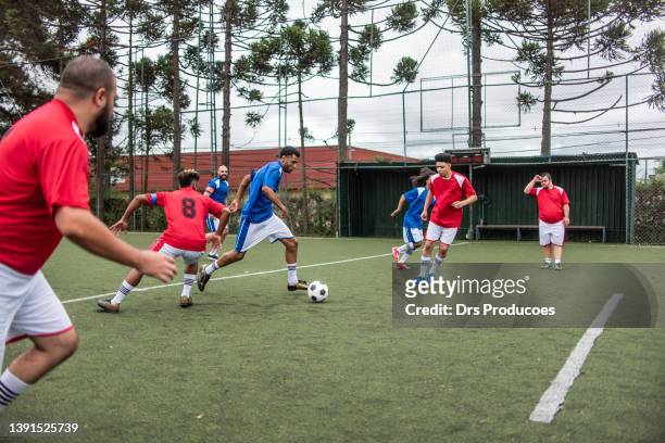 soccer players vying for the ball - club football stock pictures, royalty-free photos & images