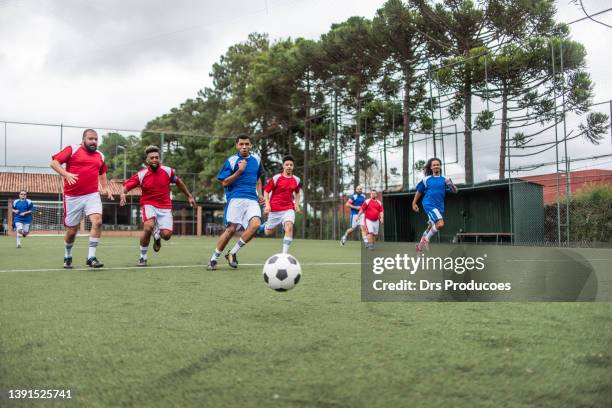soccer players vying for the ball - black male feet stockfoto's en -beelden