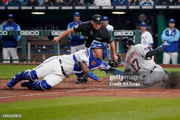 Austin Meadows of the Detroit Tigers is tagged out by Salvador Perez of the Kansas City Royals as he tries to score on a Miguel Cabrera single in the...