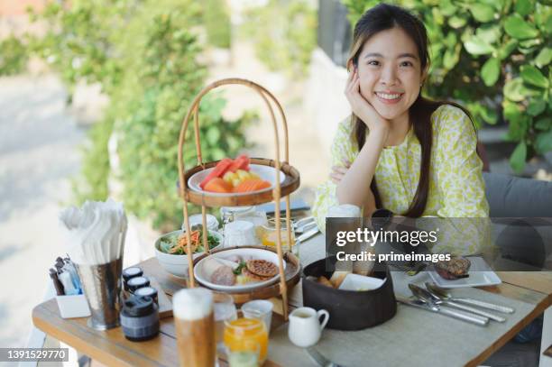 luxury happy cheerful asian women enjoy eat luxury healthy breakfast italian food and thai tradition food and friut decoration with river view at ayutthaya thailand - ayuthaya stock pictures, royalty-free photos & images