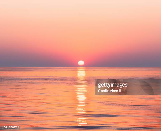 sunset on open ocean - sunset over beach stock pictures, royalty-free photos & images