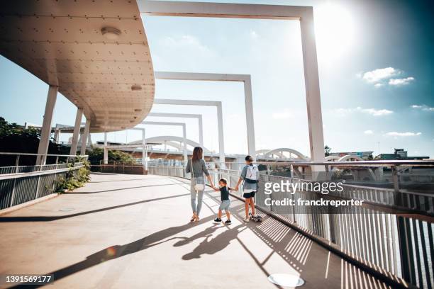 family holding hands on the street in brisbane - queensland city australia stockfoto's en -beelden