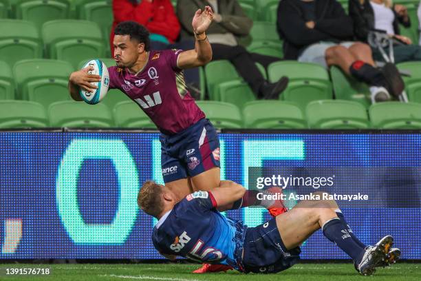 Hunter Paisami of the Reds gets tackled by Reece Hodge of the Rebels during the round nine Super Rugby Pacific match between the Melbourne Rebels and...