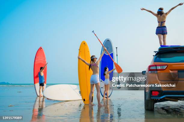 summer in group - car splashing water on people stock pictures, royalty-free photos & images