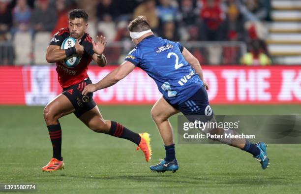 Richie Mo'unga from The Crusaders tries to avoid Kurt Eklund from the Blues during the round four Super Rugby Pacific match between the Crusaders and...