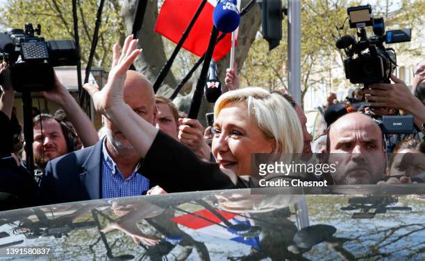 France's far-right party Rassemblement National leader, Marine Le Pen candidate for the 2022 French presidential election waves supporters after her...