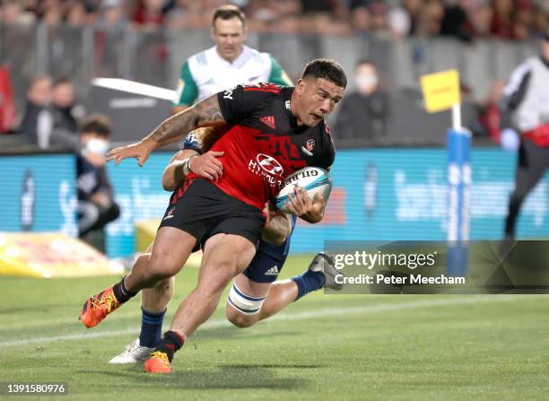 Codie Taylor from The Crusaders is tackled by Tom Robinson from the Blues during the round four Super Rugby Pacific match between the Crusaders and...