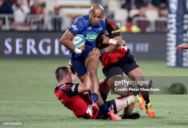 Mark Telea from the Blues is tackled by Zach Gallagher, left, and George Bower from The Crusaders during the round four Super Rugby Pacific match...