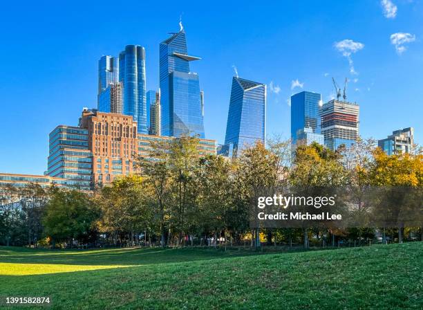 skyline view of hudson yards and manhattan west from pier 62 in new york - hudson yards stock pictures, royalty-free photos & images