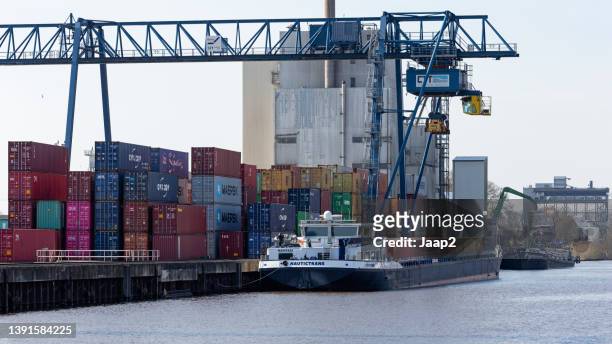 cargoship 'nautictrans' being loaded at the container terminal in hengelo - container ship stock pictures, royalty-free photos & images