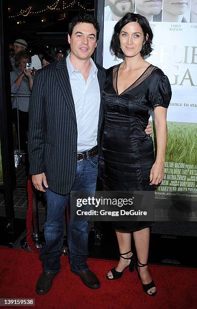 Carrie-Anne Moss and husband Steven Roy arrive at the Los Angeles Premiere of "Fireflies In The Garden" at the Pacific Theatre at The Grove on...