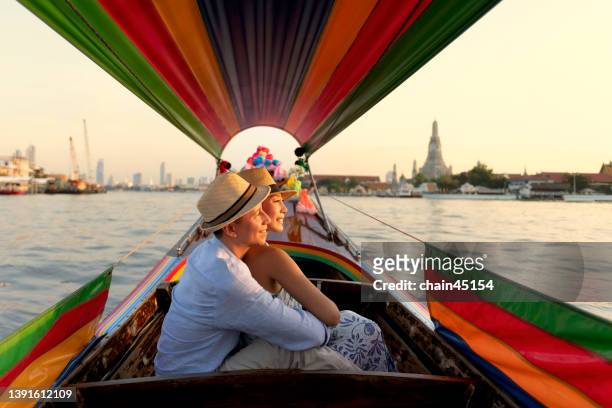 lover couple journey around city for sightseeing landmarks by long tail boat. local travel destination. - thai ethnicity stock-fotos und bilder
