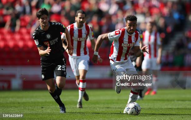 Jacob Brown of Stoke City runs with the ball from Timm Klose of Bristol City during the Sky Bet Championship match between Stoke City and Bristol...