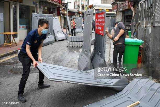 Workers remove fences at a residential community after the city lifted the Covid-19 lockdown on April 14, 2022 in Changsha, Hunan Province of China.