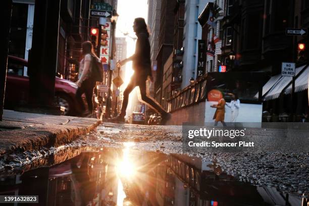 People walk down a street in downtown on April 14, 2022 in Philadelphia, Pennsylvania. In a controversial move, the city of Philadelphia is...