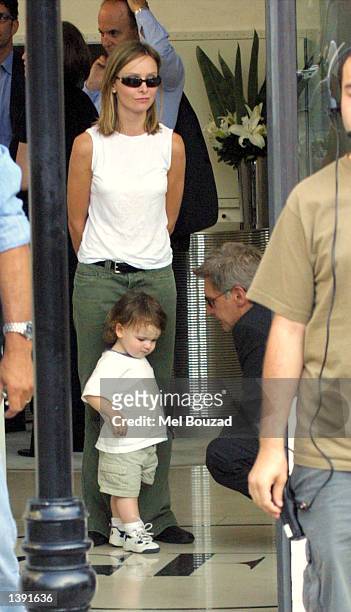 Actor Harrison Ford plays with actress Calista Flockhart's son, Liam, as she watches on September 17, 2002 in Beverly Hills, California.