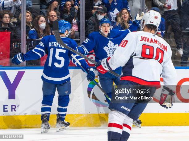 Ilya Mikheyev of the Toronto Maple Leafs celebrates his goal with Alexander Kerfoot against the Washington Capitals during the third period at the...