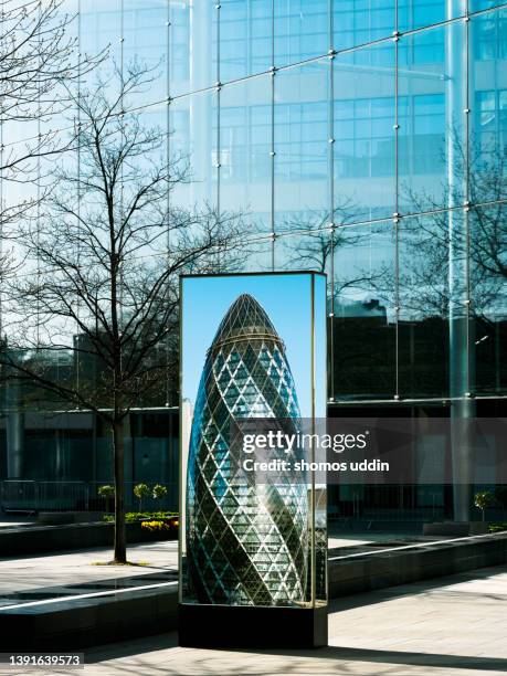 composite of billboard and modern office buildings in london city - banker doppelbelichtung stock-fotos und bilder