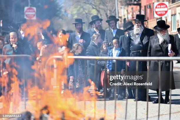 Orthodox Jews participate in the "biur chametz," a burning leavened food ritual, before the week-long Passover holiday in Williamsburg on April 15,...