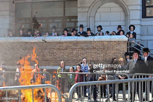 Orthodox Jews participate in the "biur chametz," a burning leavened food ritual, before the week-long Passover holiday in Williamsburg on April 15,...