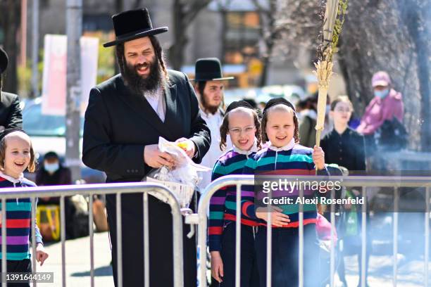 Orthodox Jews participate in the "biur chametz," a burning leavened food ritual, before the week-long Passover holiday in Williamsburg on April 15,...