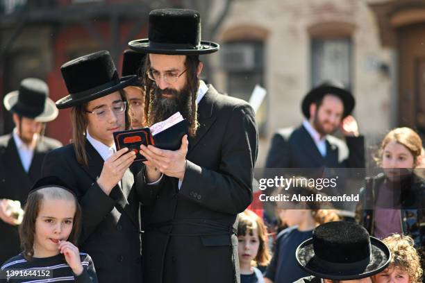 Orthodox Jews pray during the "biur chametz," a burning leavened food ritual, before the week-long Passover holiday in Williamsburg on April 15, 2022...