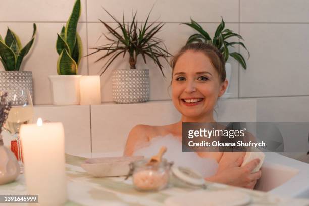woman in bath with aroma soap - bath salt ストックフォトと画像