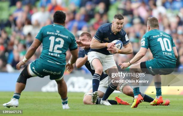 Johnny Sexton of Leinster is challenged by Jack Carty of Connacht during the Heineken Champions Cup Round of 16 Leg Two match between Leinster Rugby...