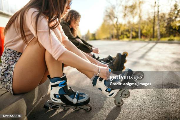 preparing for roller skating - inline skate stock pictures, royalty-free photos & images