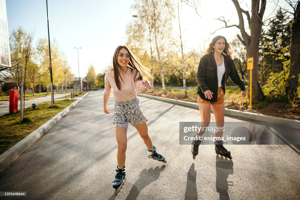 Young women skating on a sunny day