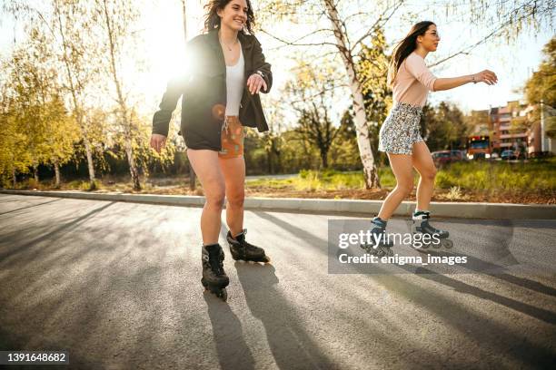 young women skating on a sunny day - inline skate stock pictures, royalty-free photos & images