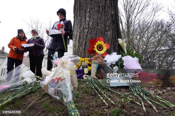 Members of the Church of the Servant pray and lay flowers at a small memorial near the spot where Patrick Lyoya was killed on April 15, 2022 in Grand...