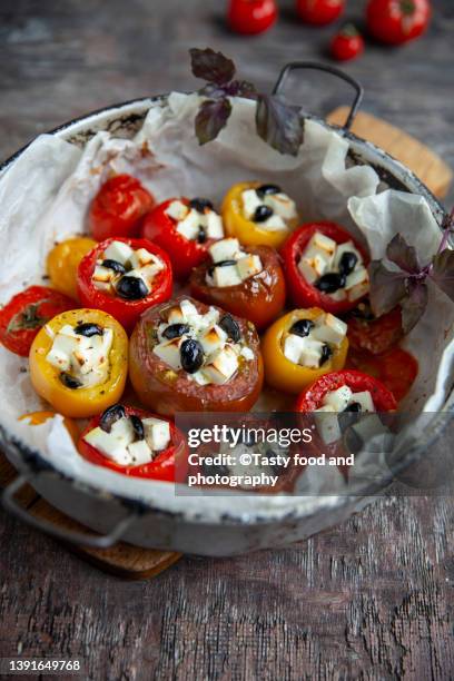 tomato stuffed with feta and olives - feta cheese stock-fotos und bilder