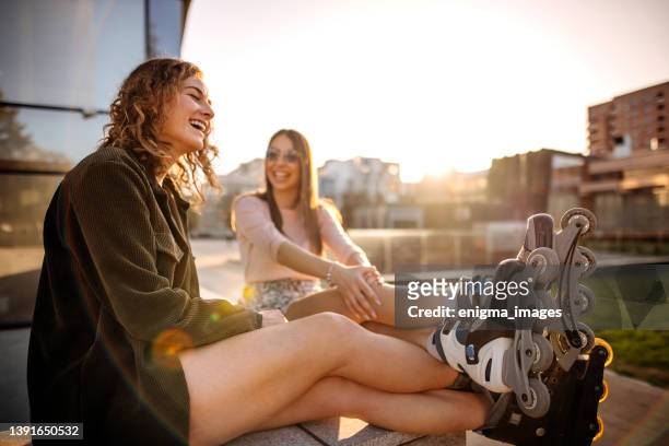 friends resting in park after rollerblading - inline skate stock pictures, royalty-free photos & images