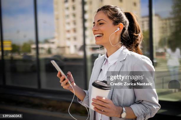 woman with headphones putdoors - white smart phone stock pictures, royalty-free photos & images
